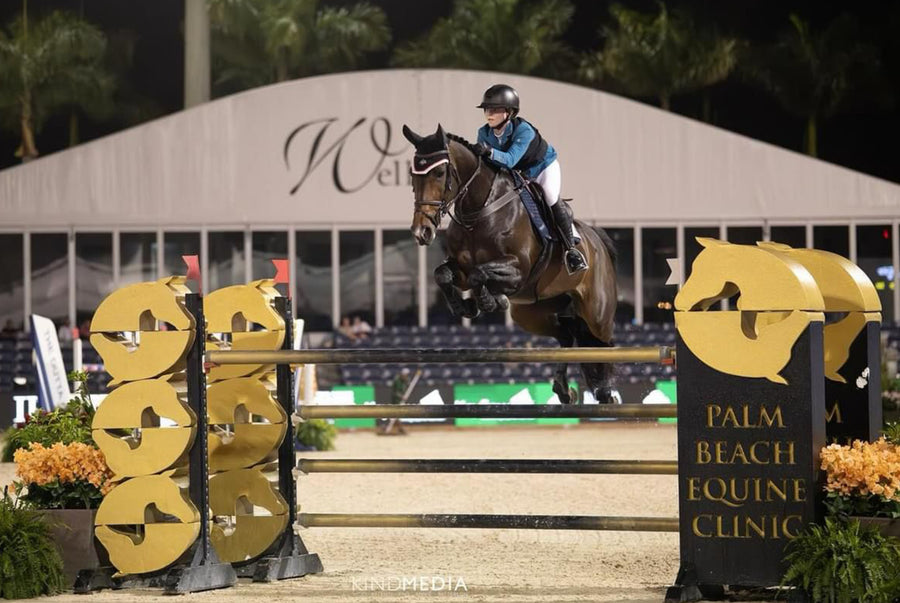 Olivia Sweetnam jumping over the Palm Beach Equine Clinic sponsor jump at the WInter Equestrian Festival