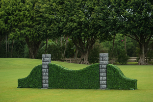 Arched turf hunter jump wall with stone pillar standards